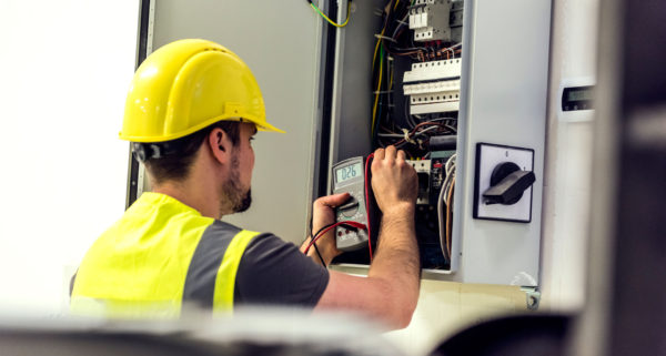 electrician working at electrical panel